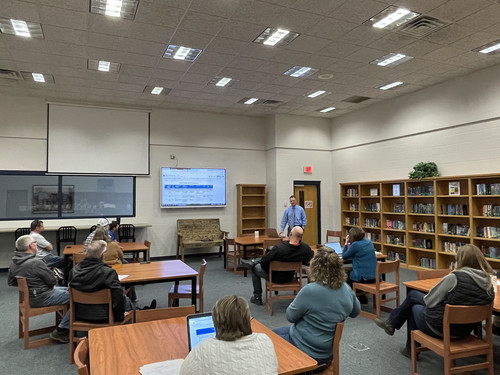 People listening to a presentation in the library